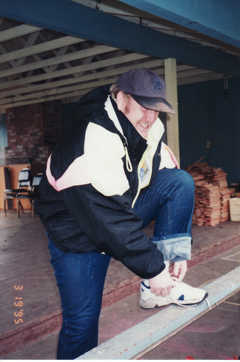 Ties his shoe